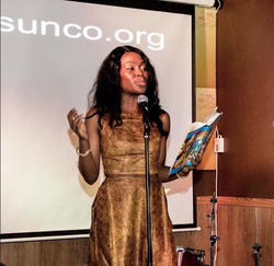 Lolade Siyonbola performing spoken word at a poetry event.