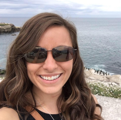 Selfie of Meredith Chapman wearing her sunglasses near the beach.