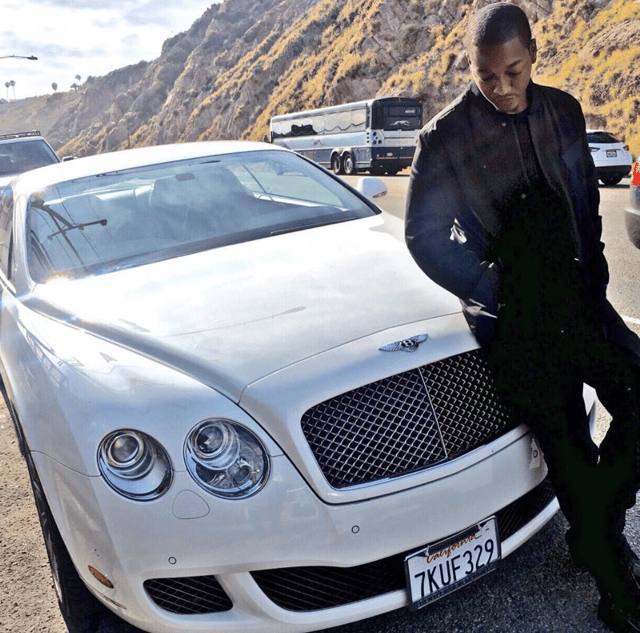 Nathan poses next to a Bentley.