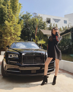 Nicolette Gray posing with her Rolls Royce.