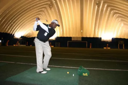 Photo of Oscar Lemar Owensby practicing his golf swing.
