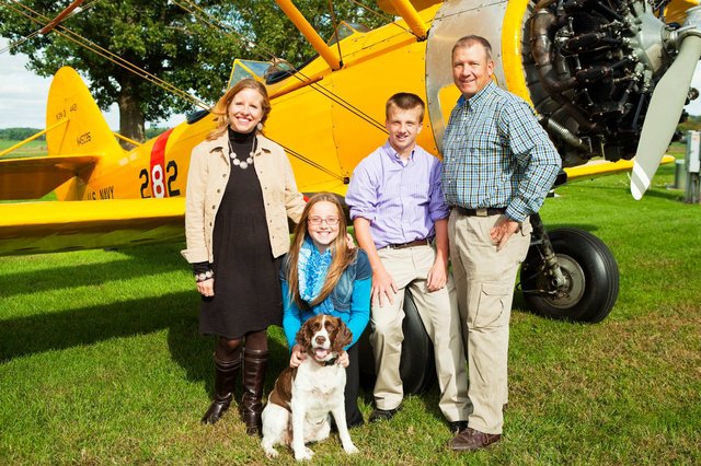 Photo of Owen with his family in front of their plane