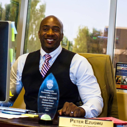 Sitting at his desk