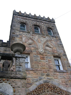 At the top of the building, one can see the shimmering circles in the stone which are pieces left of the mirrors Pietro added into his building.