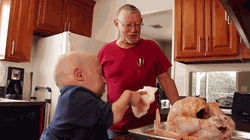Gif of Reuben Troyer with his son, Verne Troyer from a cooking segment they did together.