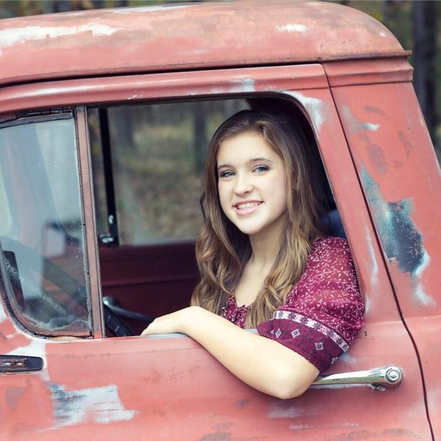 Sarah in an old truck