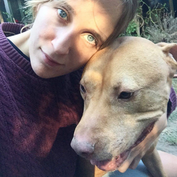 Photo of Sarah Tither-Kaplan with a dog.