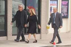 Mayor Megan Barry walks to her son's visitation with her husband Bruce and Sgt. Robert Forrest.